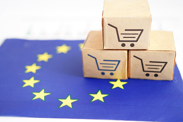 Image of European Union flag with small boxes on top which have a shopping cart printed on them