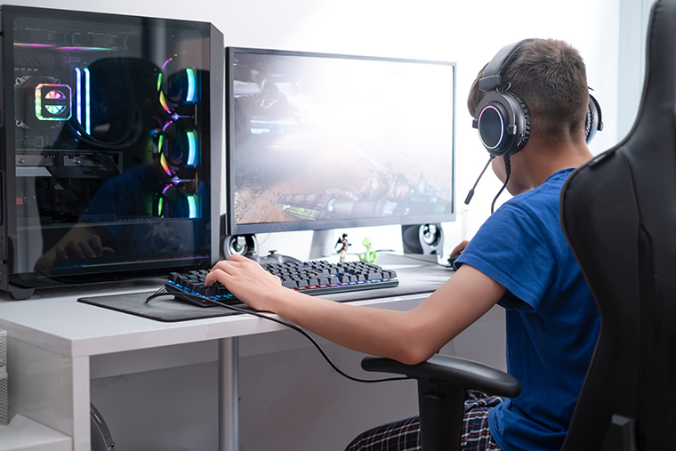 Image of young video game user playing on a PC gaming system