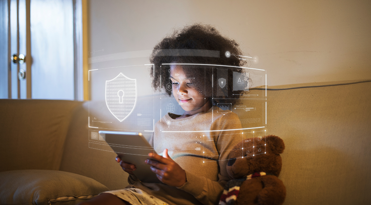 Image of a child playing a game on a table with security warnings in the foreground